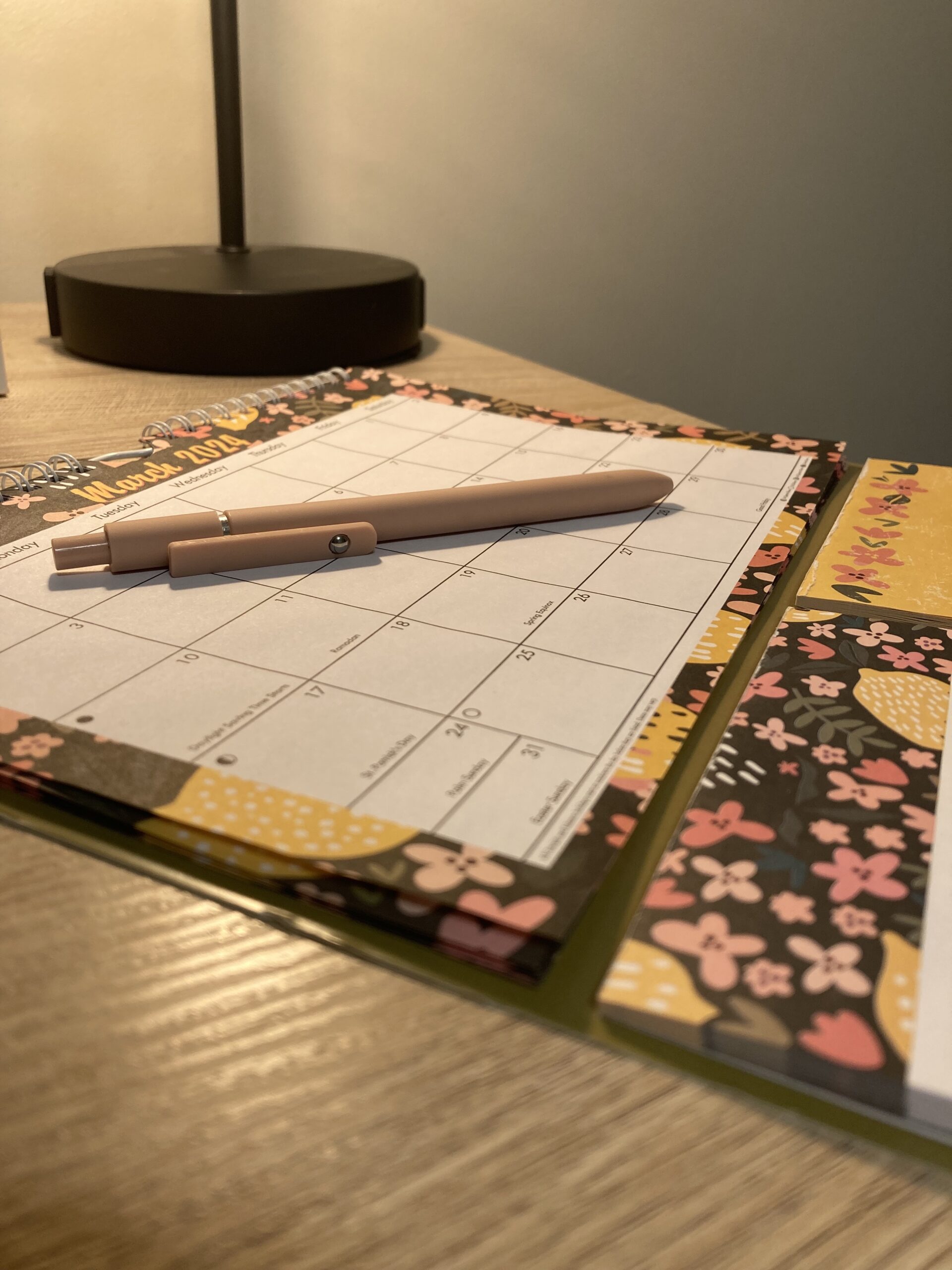 Calendar with pen on top lit by lamp light photo credit: Kati Kirst